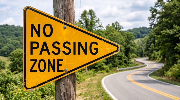 Pennant no passing sign is yellow with black letters and points right like a sideways triangle