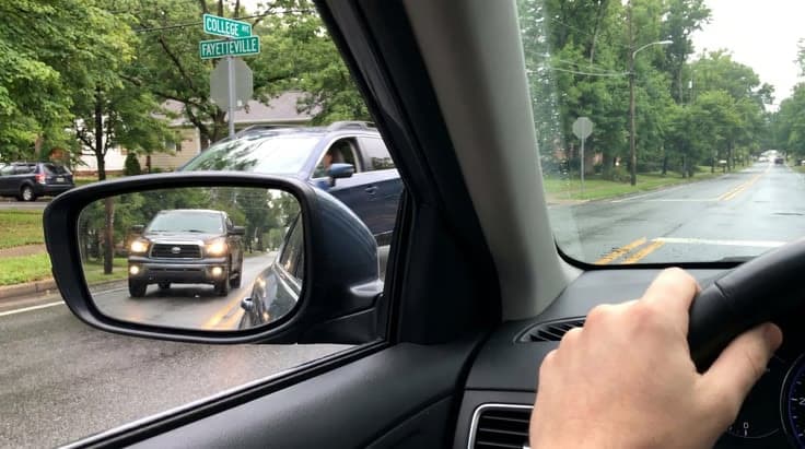 Arkansas left-turn yielding illustration: driver must wait for oncoming vehicle, as described in the DMV practice test and handbook